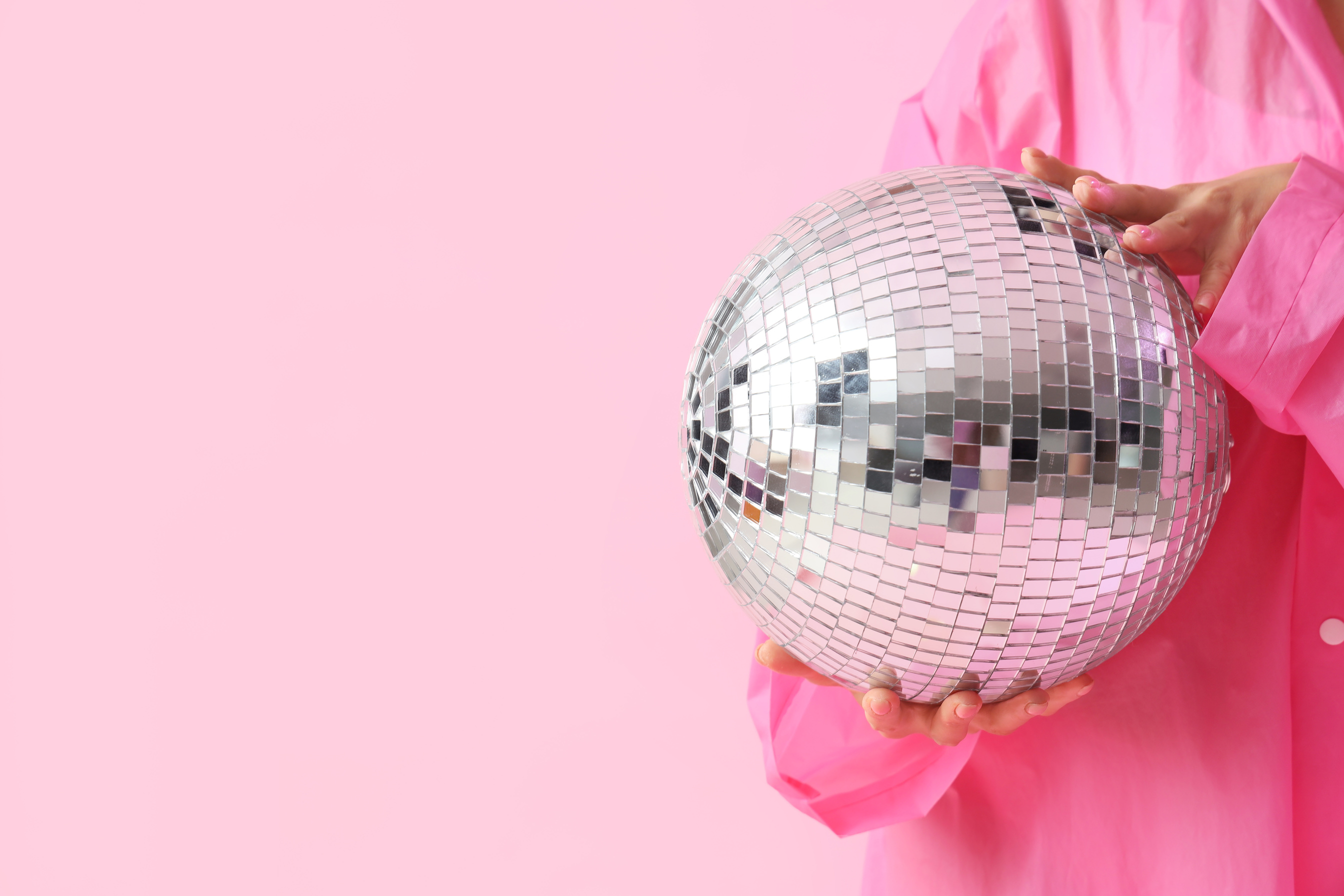 Fashionable Woman with Disco Ball on Pink Background